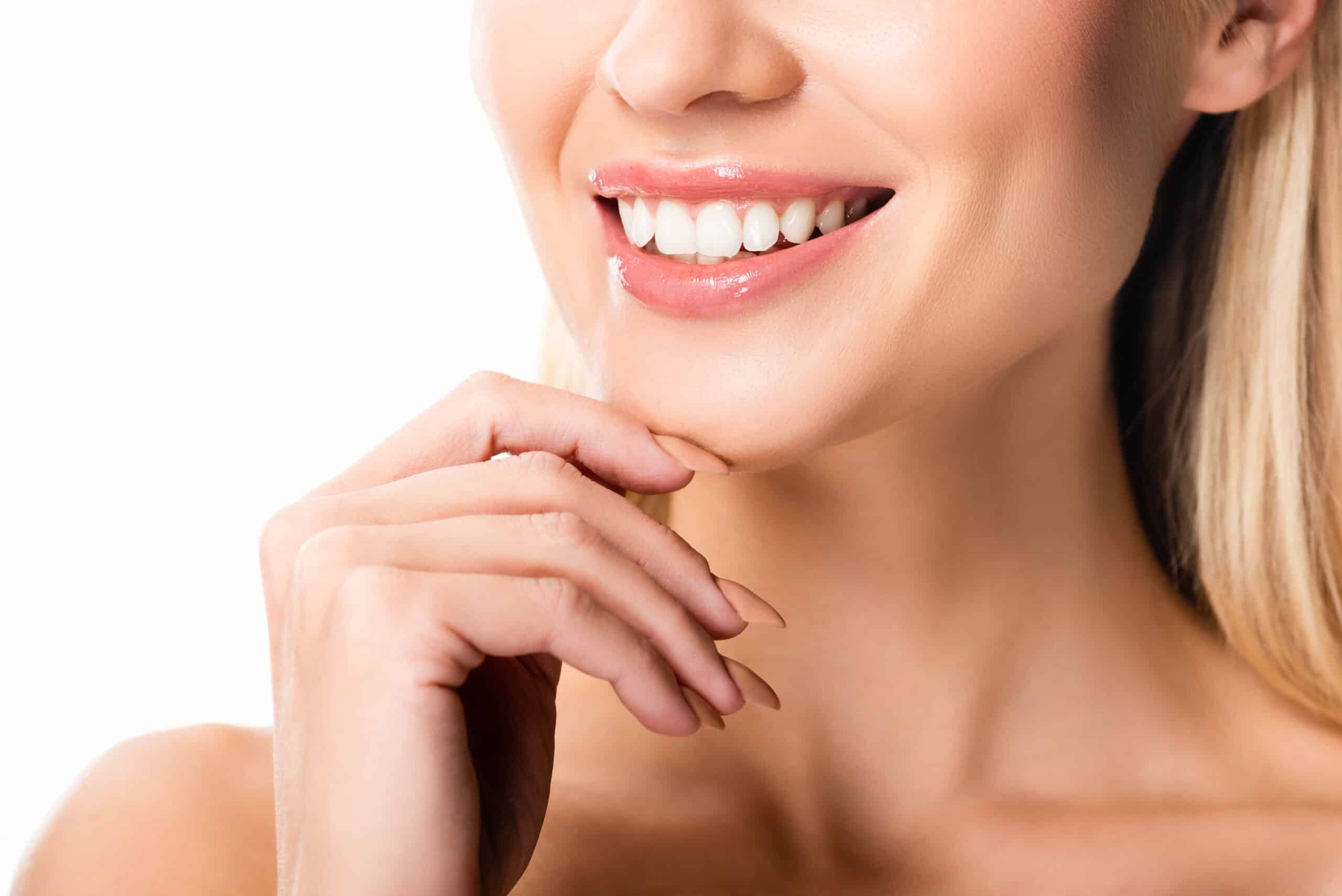 partial view of naked smiling woman with white teeth isolated on white